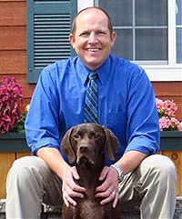 Dr. Justin Vaughn and Carter, his German Shorthair, at All Creatures Great and Small Vet Clinic in Corvallis, Oregon.